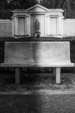 Photograph of a Distorted Bench In Front of a Neoclassical Facade in Rome