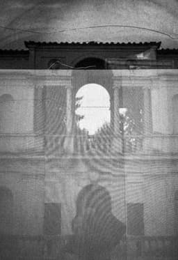 Photograph of Cracks and Distortion atop a Neoclassical Arch