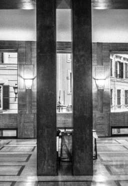 Photograph of an Erratically Lit Interior Bisected By Vertical Structural Bars