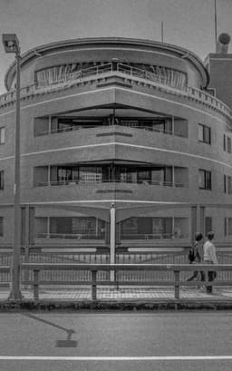 Photograph of a Ship-like Building in Tokyo with Passerby
