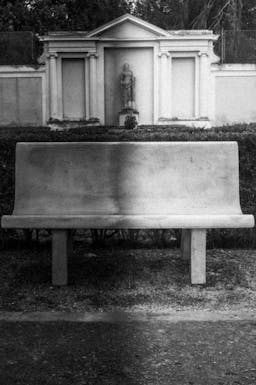Photograph of a Distorted Bench In Front of a Neoclassical Facade in Rome
